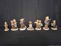 All seven Goebel figurines lined up
