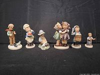 All six Goebel Hummel figurines side by side