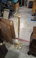 Full view of gold-tone floor lamp