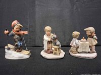 Front view of all three Goebel Hummel figurines