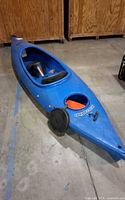 Overall view of blue Perception kayak, side angle