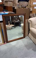 Front view of rectangular wood-framed mirror