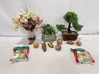 Entire lot overview showing bouquet, succulent planter, bonsai, pods/balls and two packaged foam blocks