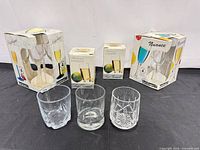 Group shot of all boxes and three loose glasses