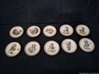 All ten Hummel saucers laid out face up