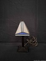 Front view of small stained glass table lamp showing shade design, base, and cord