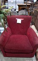 Front view of red upholstered armchair
