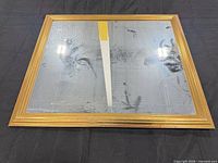 Front view of rectangular gilt-frame mirror showing glass foxing and frame detail