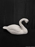 Overall view of white swan statue showing full form and feather detail