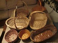 Top view of seven assorted wicker baskets on table