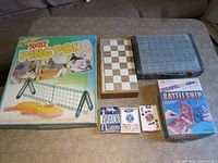All boxed games and card decks arranged on table