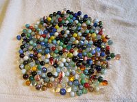 Spread of mixed-colour glass marbles on towel