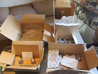 Five open boxes showing crystal items in packaging