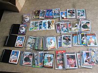 Wide shot of multiple stacks and rows of Orioles baseball cards on a table