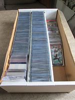 Full cardboard storage box showing two rows of sleeved Ravens football cards