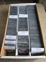 Three-row box packed with sleeved football cards, labeled player dividers visible