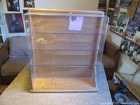 Front view of wood display case showing shelves and clear cover