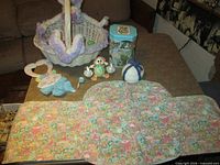 Overview showing basket, ceramic pieces, tin, runner and placemats