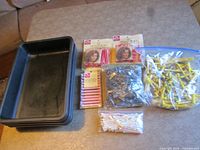 Overall view of trays, packaged perm rods, and bags of loose rods and clips