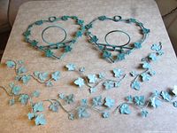 Full lot showing two heart planters and six vine accents on tabletop