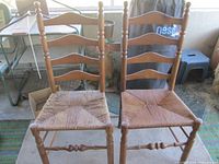 Both ladder back chairs showing overall design and seat wear