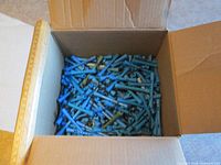 Open box filled with blue perm rods