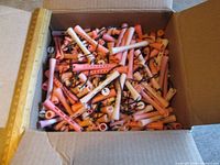 Open box filled with pink and peach plastic perm rods
