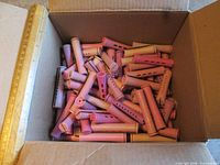 Open box filled with purple and pink perm rods