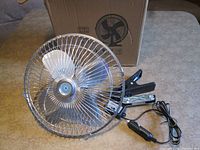 Fan, clamp, power cord and original box visible