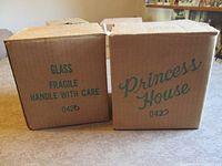 Front view of two sealed Princess House boxes marked 042