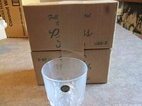 Cardboard shipping box marked Princess House with item number and one crystal whiskey glass displayed in front