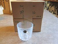 One Princess House lead crystal whiskey glass displayed in front of two original boxes