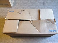 Closed cardboard box marked 0680/0890 containing glasses