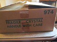 Box labeled 974 Fragile Crystal Handle With Care
