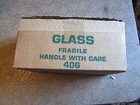 Cardboard shipping box marked GLASS FRAGILE HANDLE WITH CARE 406