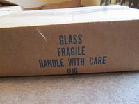 Cardboard shipping box marked Glass Fragile Handle With Care 016