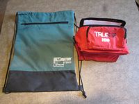 Drawstring backpack and lunch cooler side by side