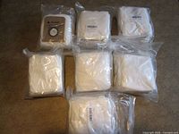 Seven sealed packs of vacuum bags displayed