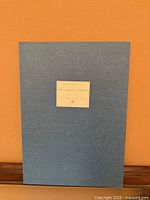 Front of blue portfolio folder with title label