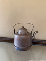 Front view of copper kettle showing handle, lid and spout