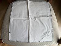 Full view of opened napkin showing size, scalloped border and embroidery