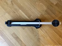 Full view of Golfsmith swing weight scale showing base and beam