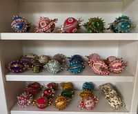 Shelf of handmade beaded ornaments, multiple colors