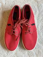 Top view of both red Polo sneakers showing laces, logo and overall condition