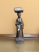 Full view of carved wooden figurine front