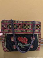 Full front view of beaded floral purse showing pattern and handles