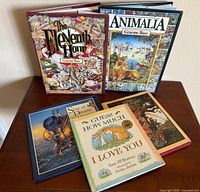 All five books displayed on table, covers visible