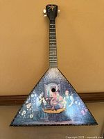 Full view of balalaika hanging on wall