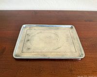Top view of rectangular metal tray showing surface and border