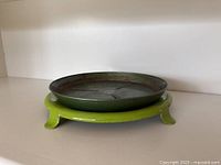 Stand with drip tray assembled, side view shows feet and tray